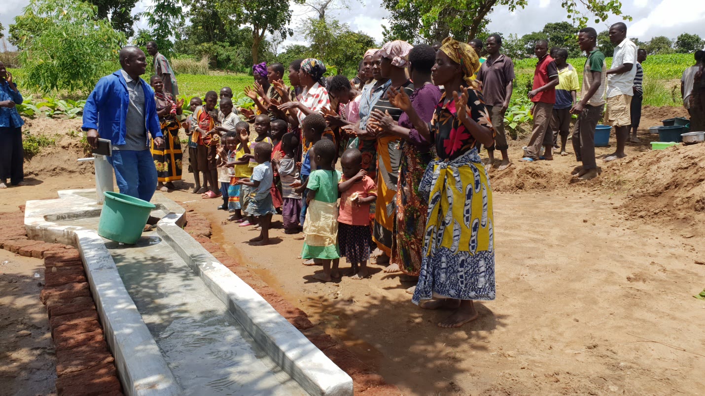 Community members gathered at an EWSFA water point